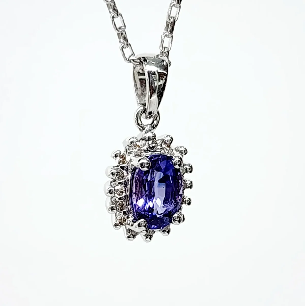 9ct White Gold 1.06ct Ceylon Sapphire with 0.10ct Diamond Halo Pendant