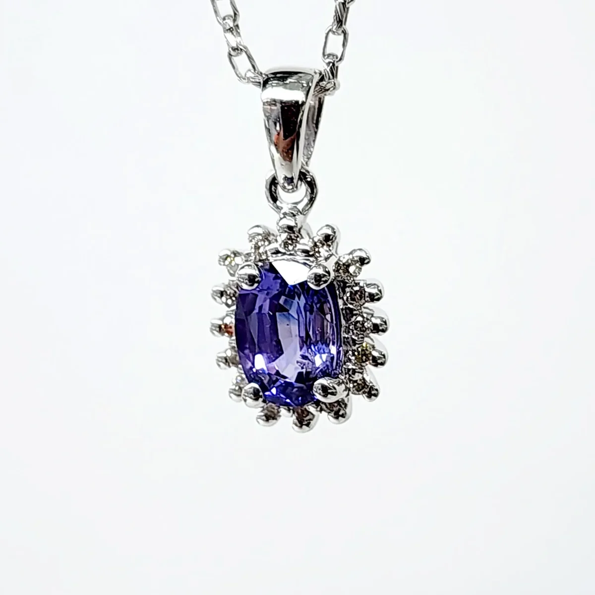 9ct White Gold 1.06ct Ceylon Sapphire with 0.10ct Diamond Halo Pendant