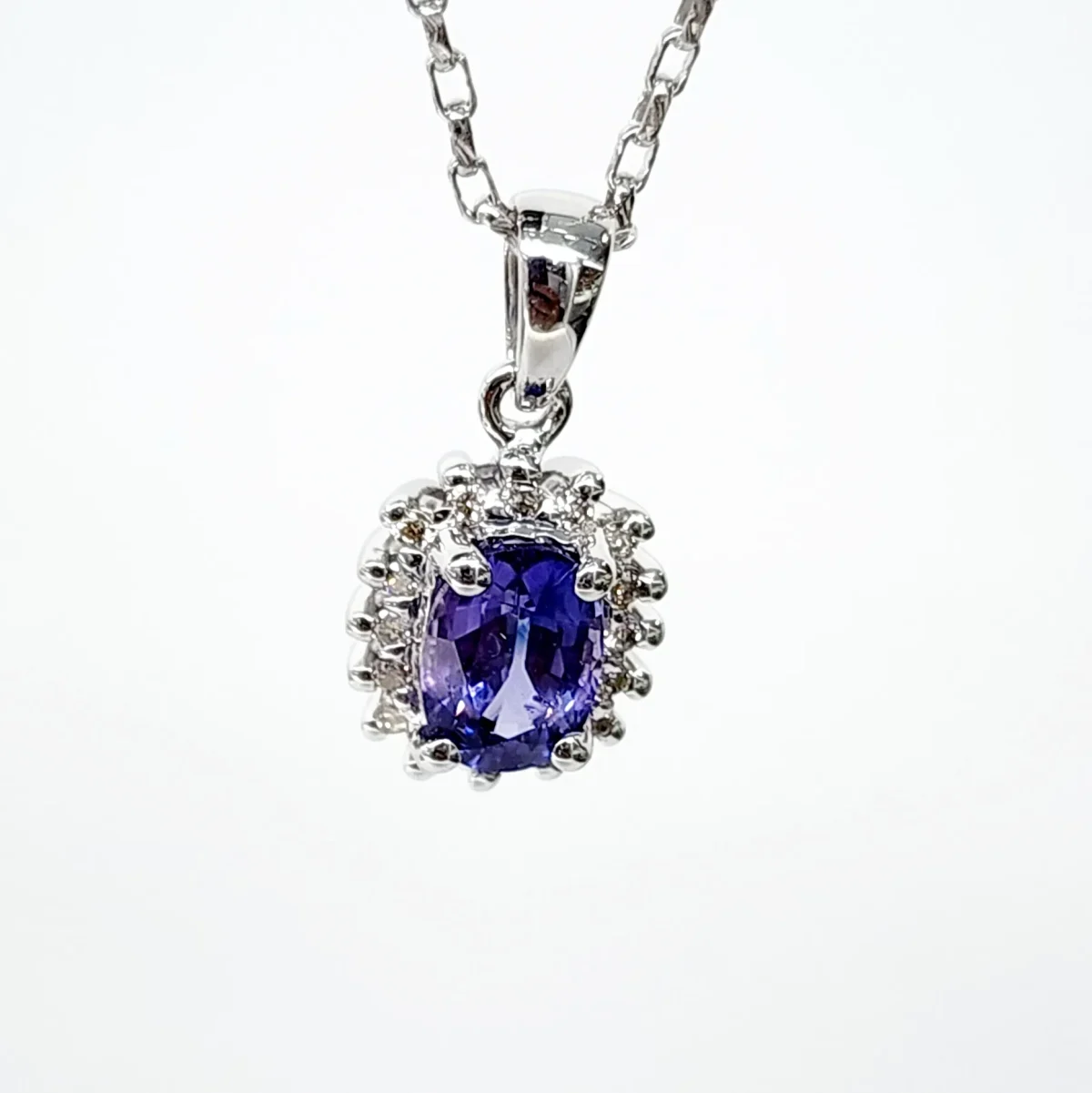 9ct White Gold 1.06ct Ceylon Sapphire with 0.10ct Diamond Halo Pendant