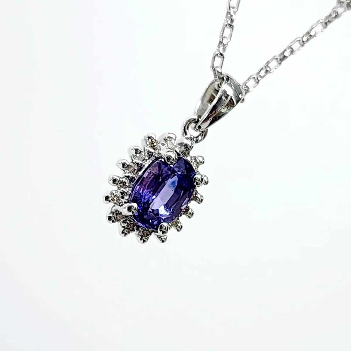9ct White Gold 1.06ct Ceylon Sapphire with 0.10ct Diamond Halo Pendant