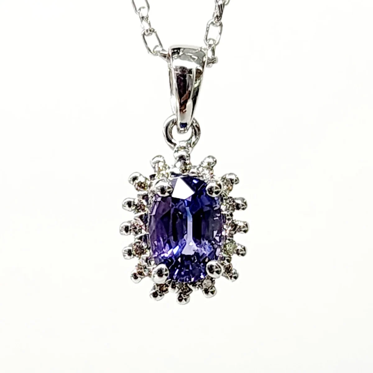 9ct White Gold 1.06ct Ceylon Sapphire with 0.10ct Diamond Halo Pendant