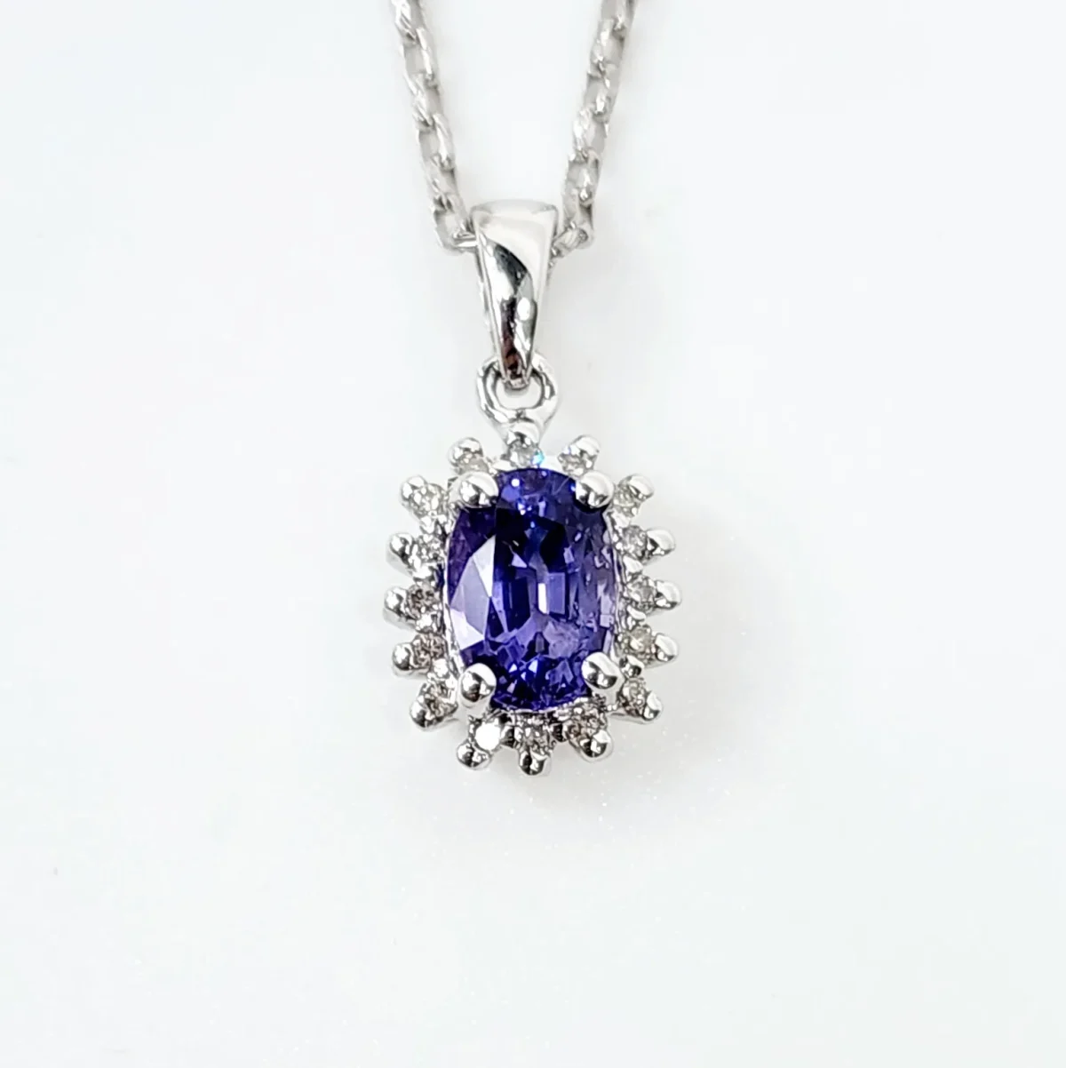 9ct White Gold 1.06ct Ceylon Sapphire with 0.10ct Diamond Halo Pendant