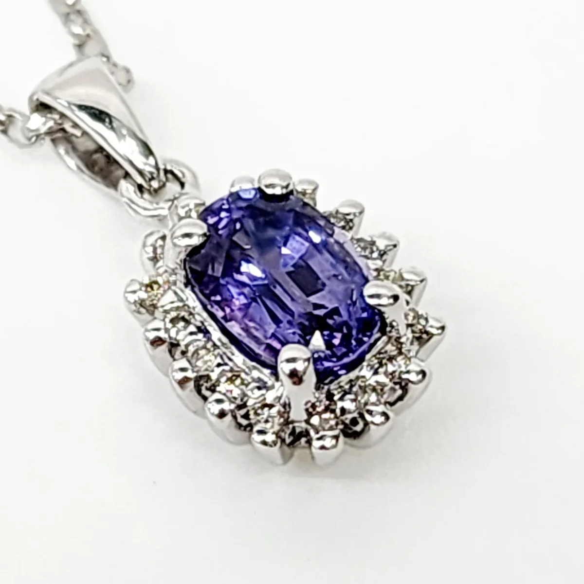 9ct White Gold 1.06ct Ceylon Sapphire with 0.10ct Diamond Halo Pendant