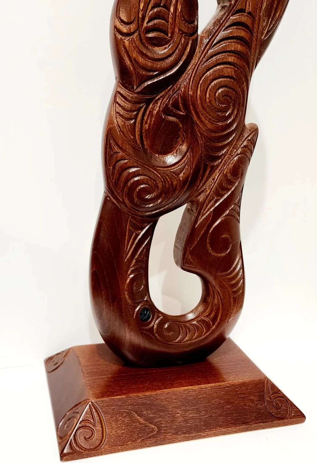 Large Carved Maori Hei Matau (Fish Hook) from Kauri Wood with Paua Shell Eyes on Stand