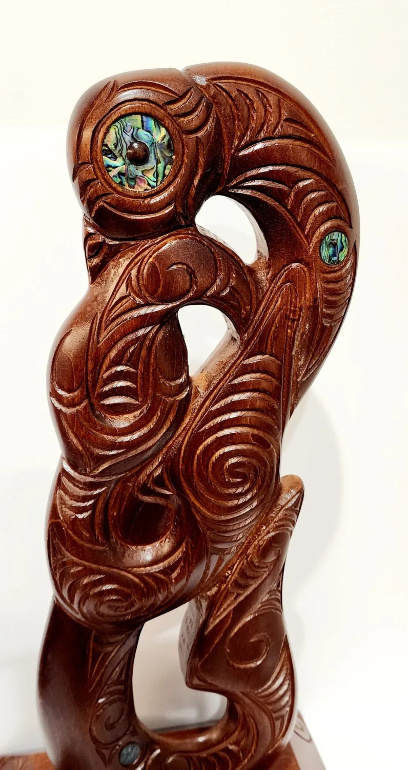 Large Carved Maori Hei Matau (Fish Hook) from Kauri Wood with Paua Shell Eyes on Stand