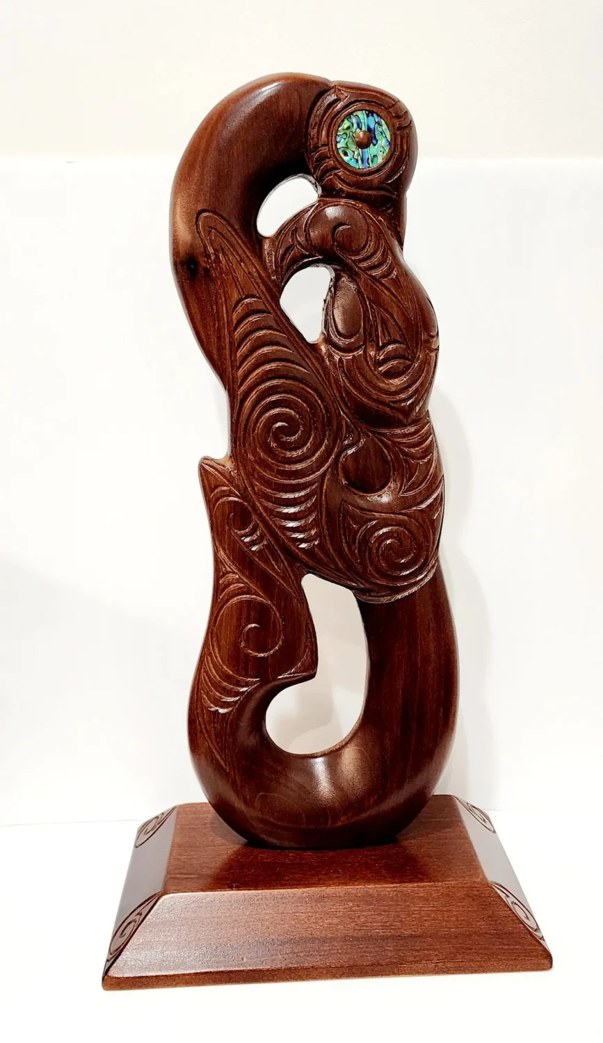 Large Carved Maori Hei Matau (Fish Hook) from Kauri Wood with Paua Shell Eyes on Stand
