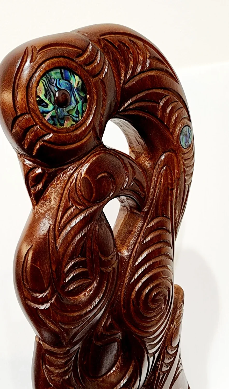 Large Carved Maori Hei Matau (Fish Hook) from Kauri Wood with Paua Shell Eyes on Stand