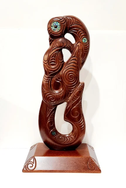 Large Carved Maori Hei Matau (Fish Hook) from Kauri Wood with Paua Shell Eyes on Stand