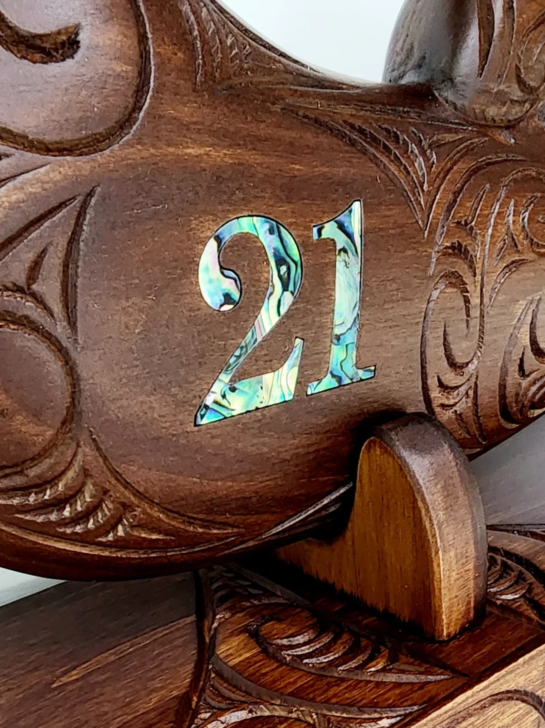 Large Carved Maori Wahaika Club with 21 Paua Inlaid on Stand