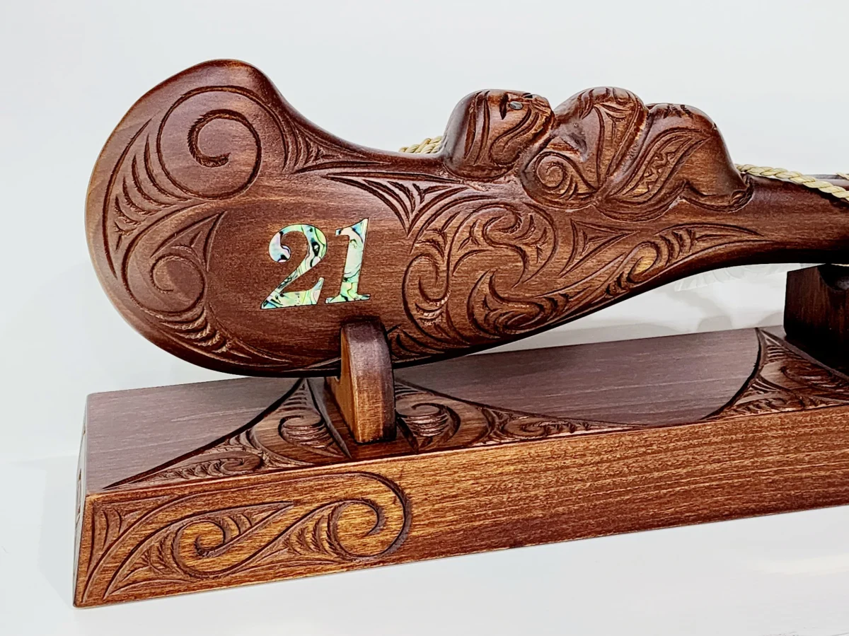 Large Carved Maori Wahaika Club with 21 Paua Inlaid on Stand
