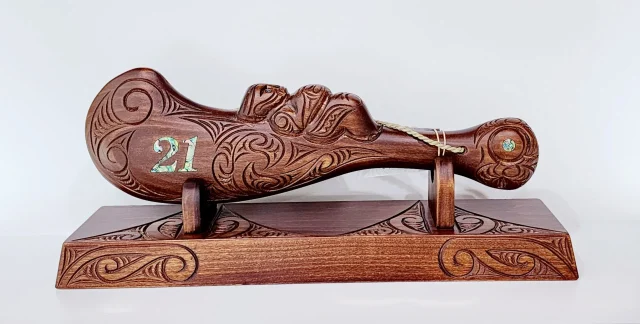 Large Carved Maori Wahaika Club with 21 Paua Inlaid on Stand