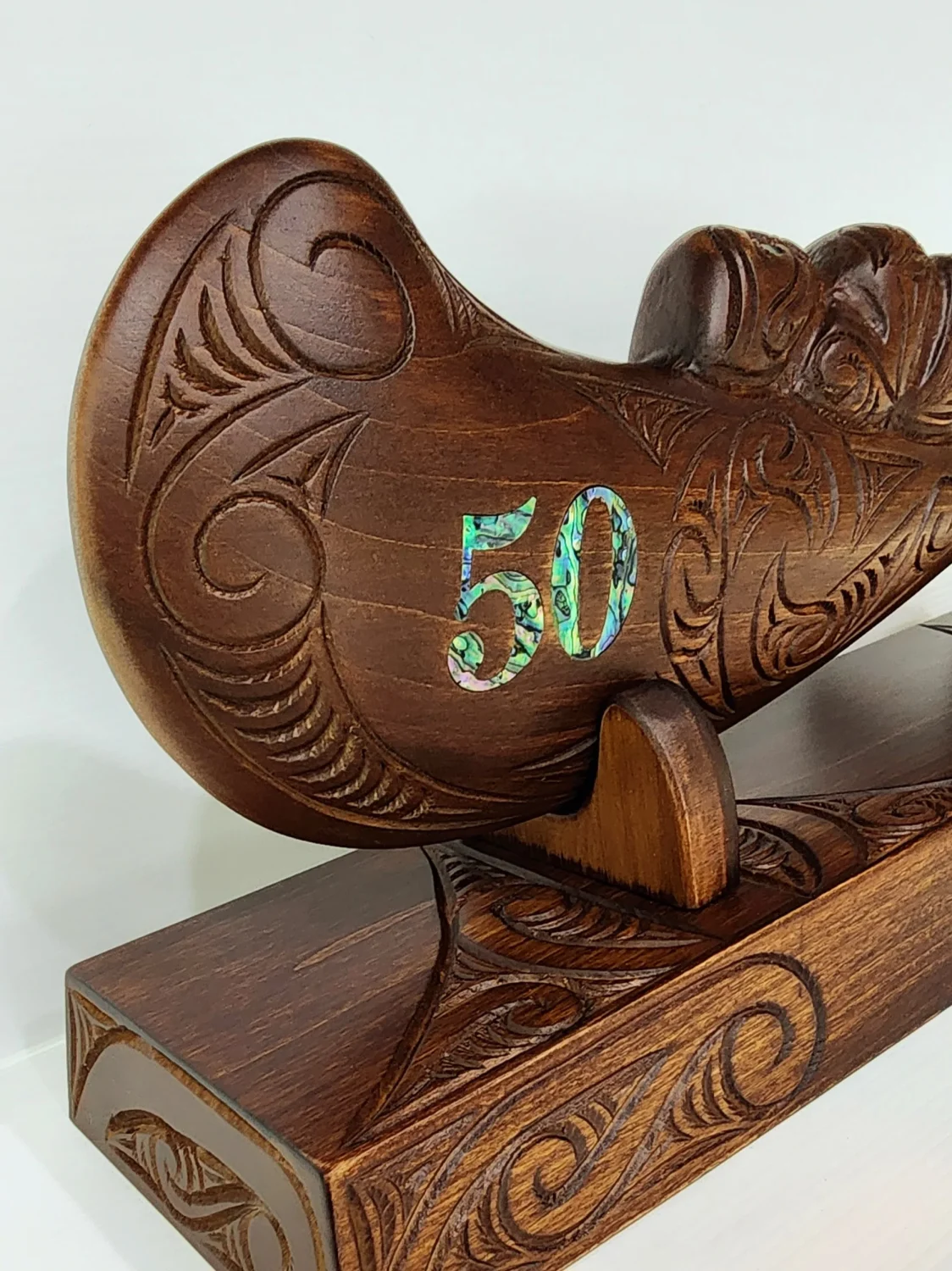 Large Carved Maori Wahaika Club with 50 Paua Inlaid on Stand