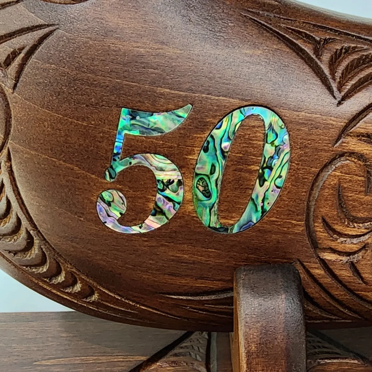 Large Carved Maori Wahaika Club with 50 Paua Inlaid on Stand