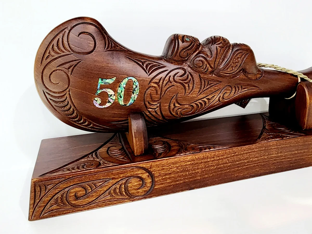 Large Carved Maori Wahaika Club with 50 Paua Inlaid on Stand