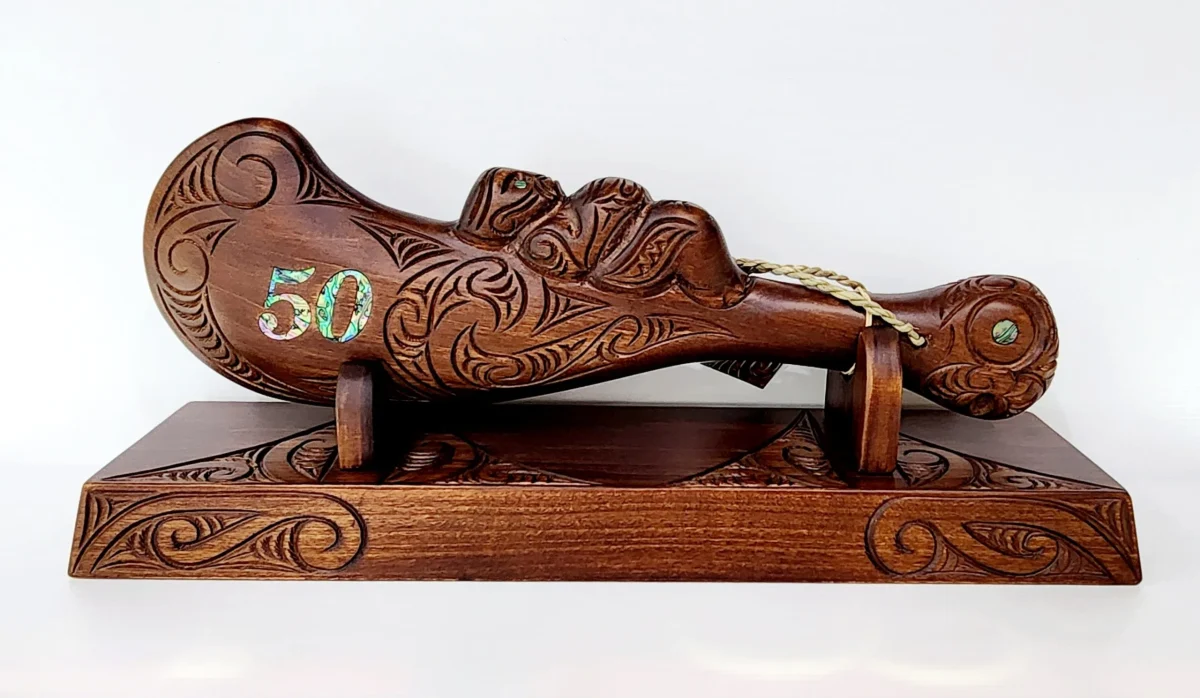 Large Carved Maori Wahaika Club with 50 Paua Inlaid on Stand