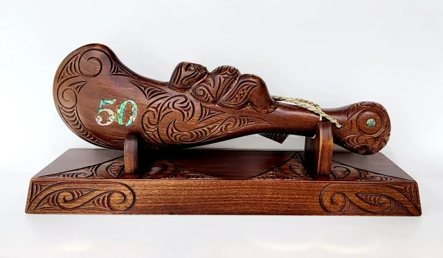 Large Carved Maori Wahaika Club with 50 Paua Inlaid on Stand