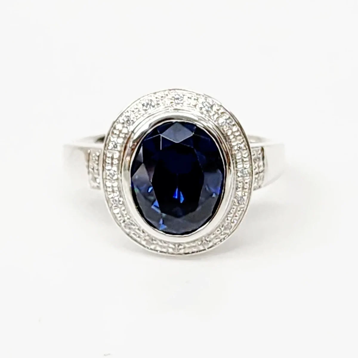 Sterling Silver 10mm x 13mm Ocal Cut Bezel Set Blue CZ and Halo CZ Setting Ladies Dress Ring