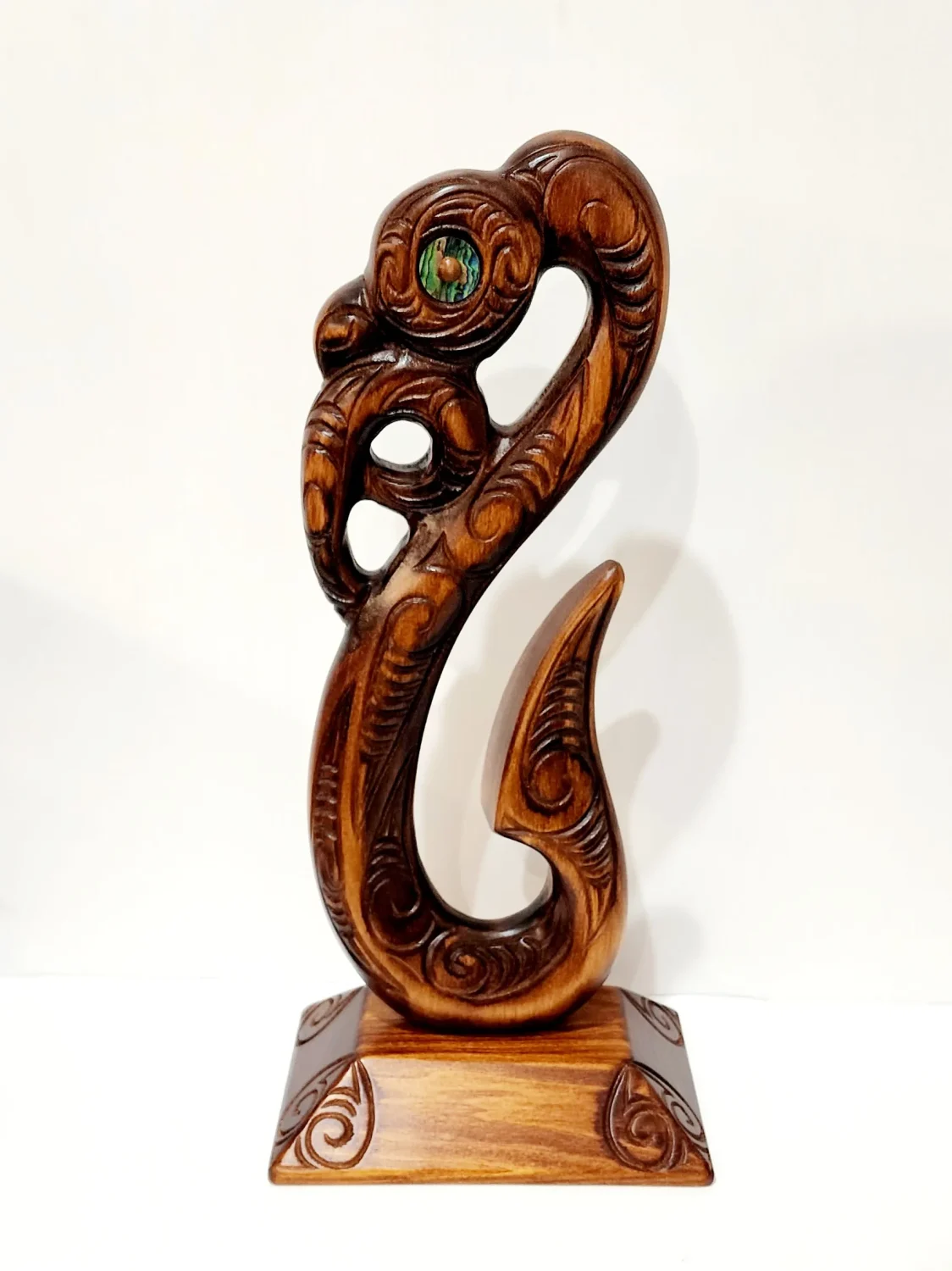 Wooden Carved Maori Fish Hook with Paua Shell Eyes on Stand