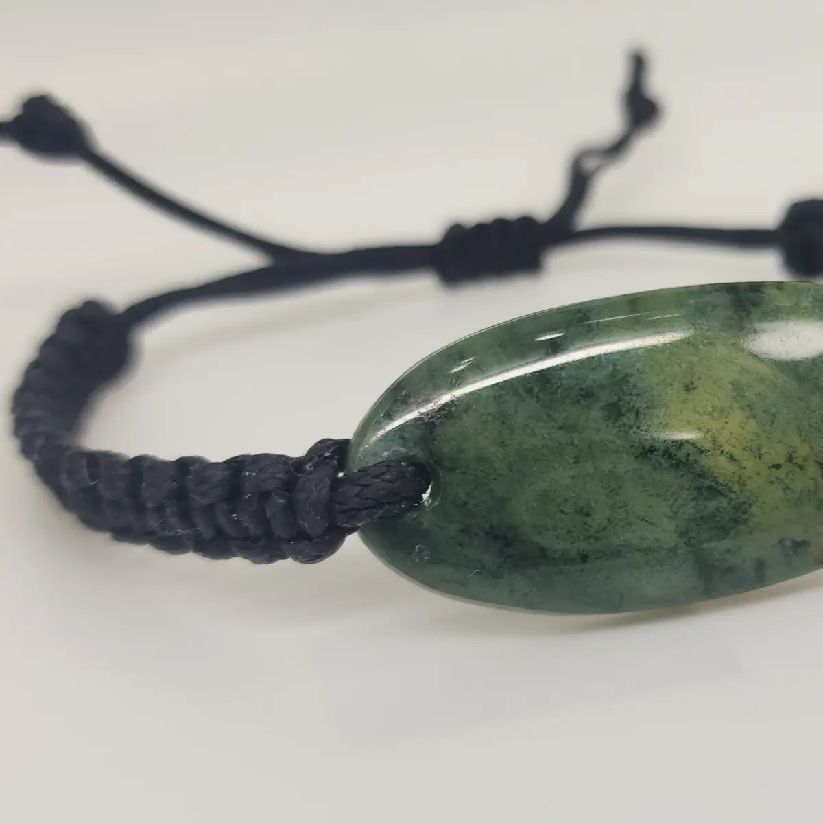 Natural New Zealand Greenstone Oval Polished Disc Bracelet – 45mm x 20mm | Black Braided Adjustable Cord