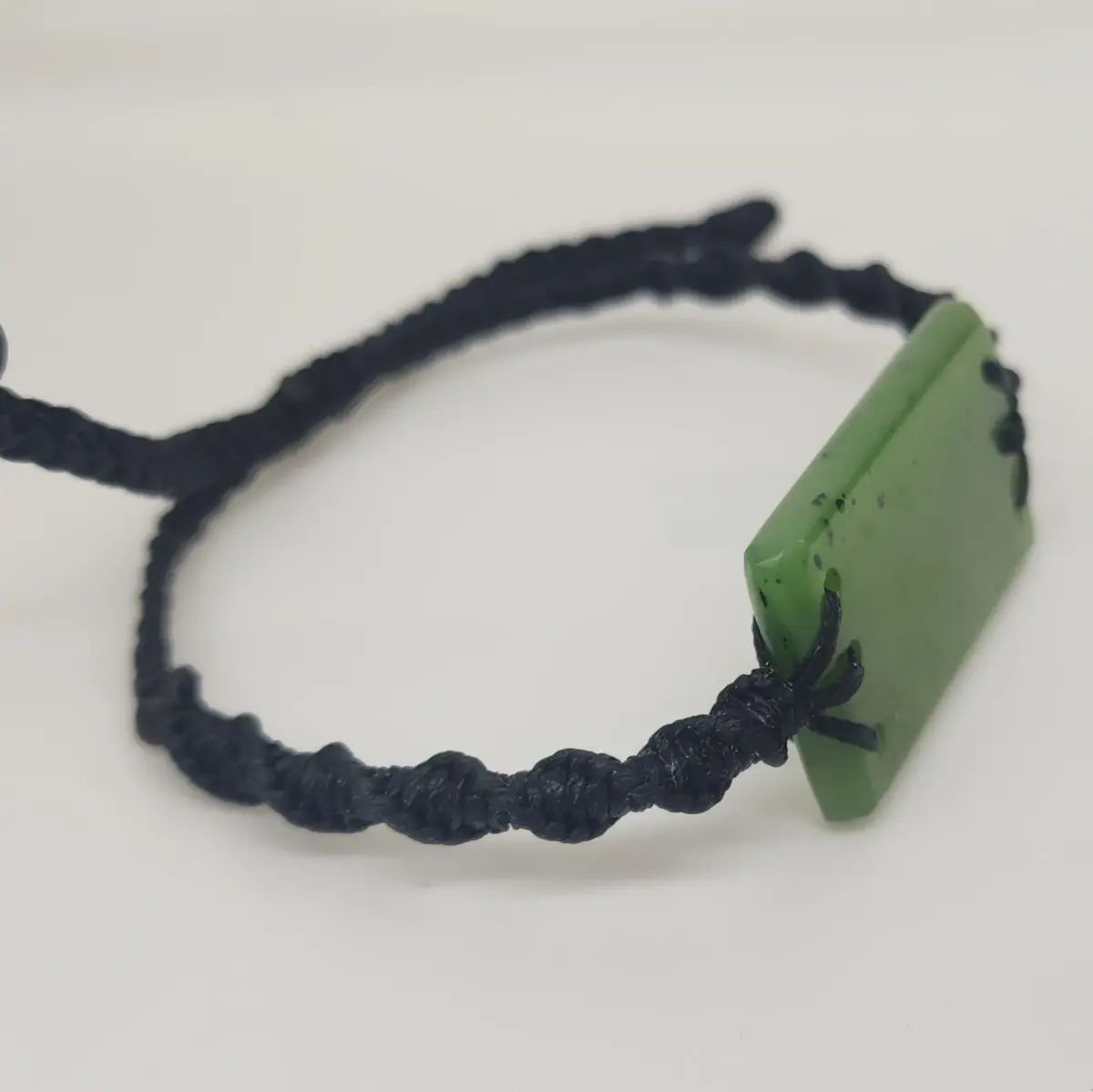 Natural New Zealand Greenstone Rectangular Bracelet – 41mm x 21mm | Black Plaited Adjustable Cord